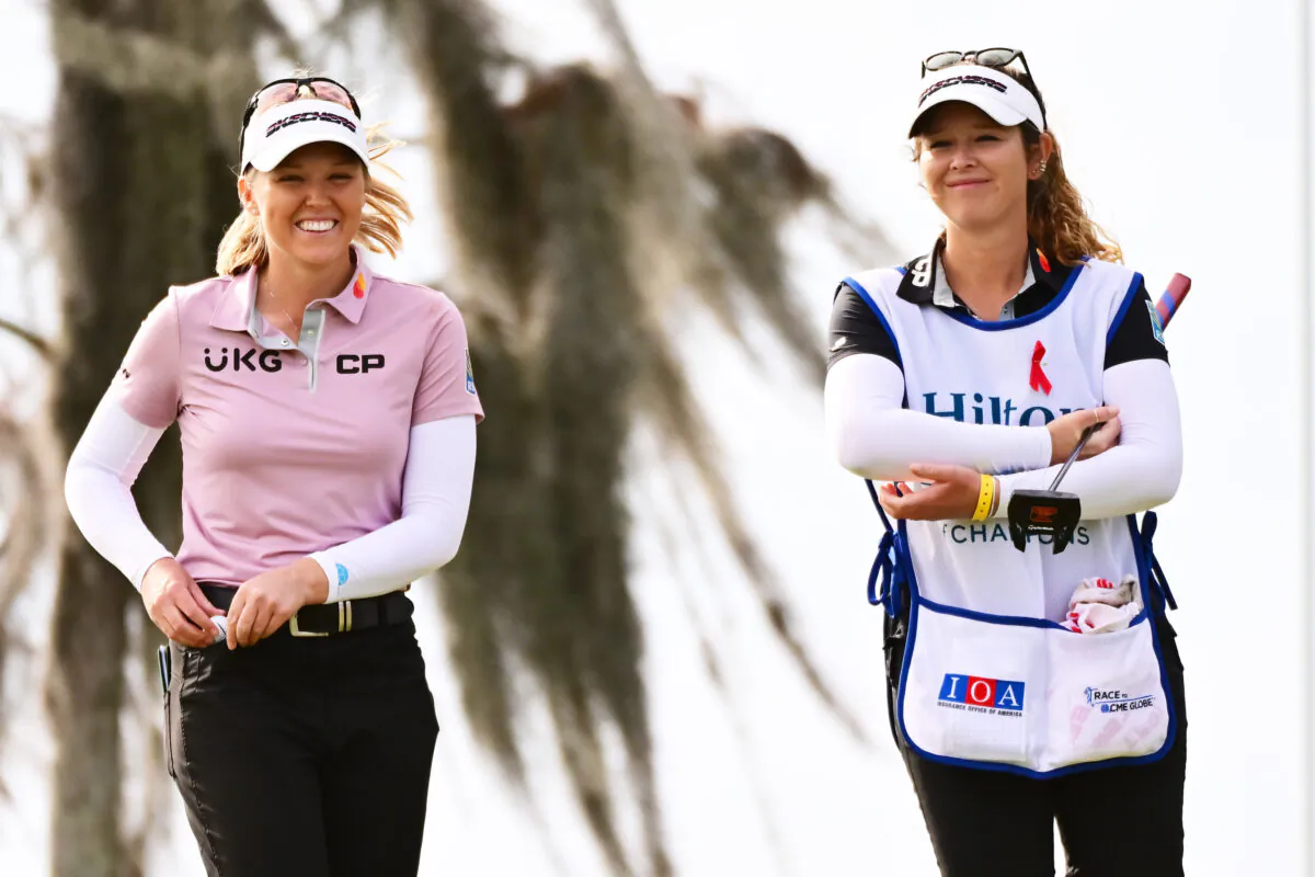 Brooke Henderson of Canada reacts with caddie Brittany Henderson after making her putt on the 18th green during the first round of the Hilton Grand Vacations Tournament of Champions at Lake Nona Golf &  Country Club in Orlando, Fla., on January 19, 2023. (Julio Aguilar/Getty Images)
