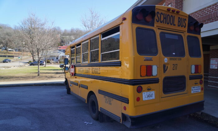 A school bus waits to pick up children outside a school in Chattanooga, Tenn. on Jan. 19, 2023. (Jackson Elliott/The Epoch Times)