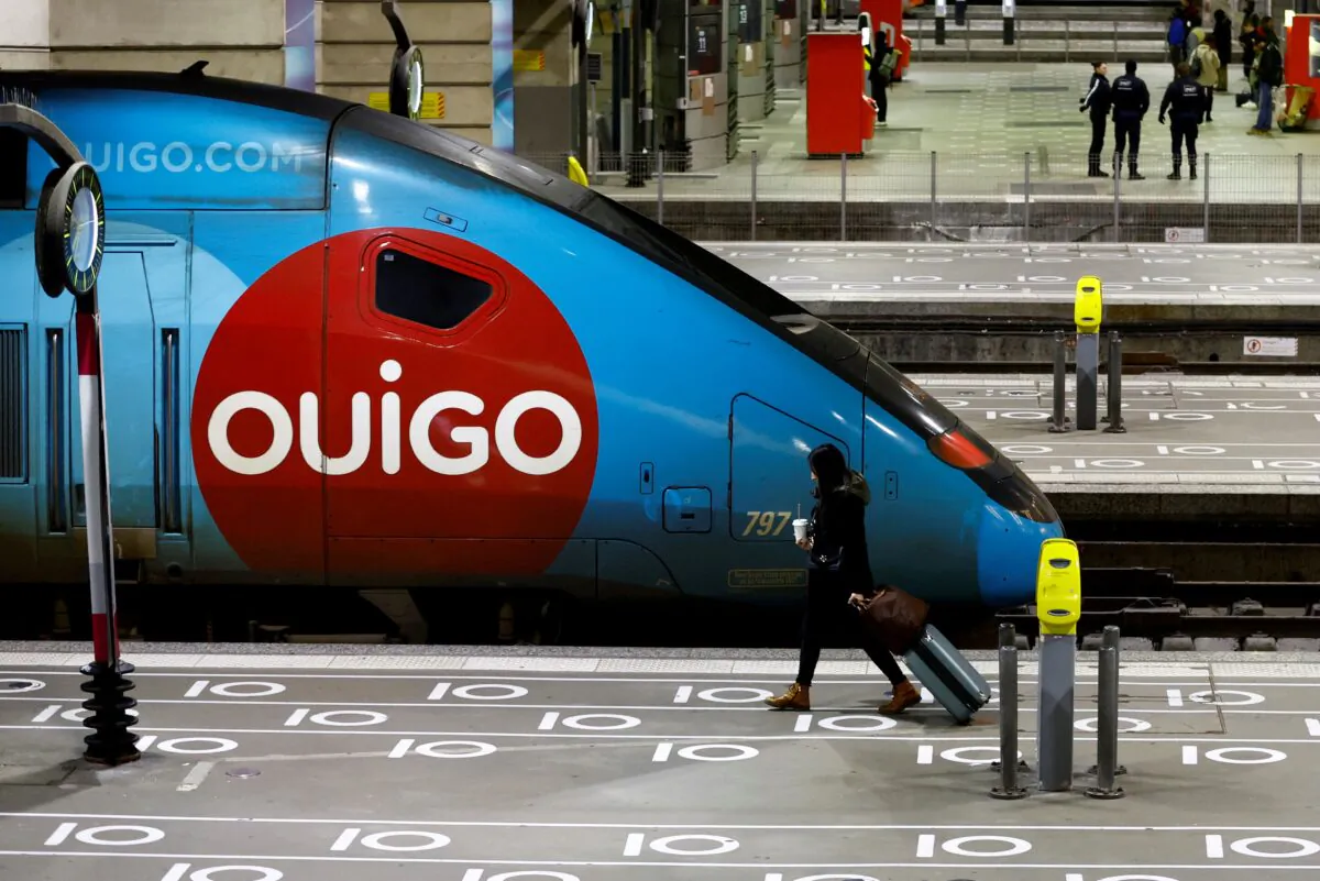 A passenger walks past a TGV Ouigo high speed train at Gare Montparnasse railway station during a strike by French SNCF workers in Paris as part of a nationwide day of strike and protests against French government's pension reform plan in France, on Jan. 19, 2023. (Gonzalo Fuentes/Reuters)