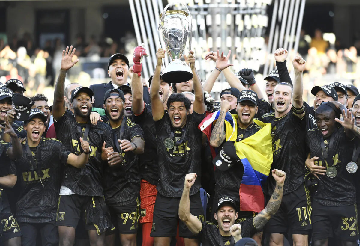 Carlos Vela (10) of Los Angeles FC lifts the championship trophy as he celebrates with teammates during the 2022 MLS Cup Final at Banc of California Stadium in Los Angeles on Nov. 5, 2022. (Kevork Djansezian/Getty Images)