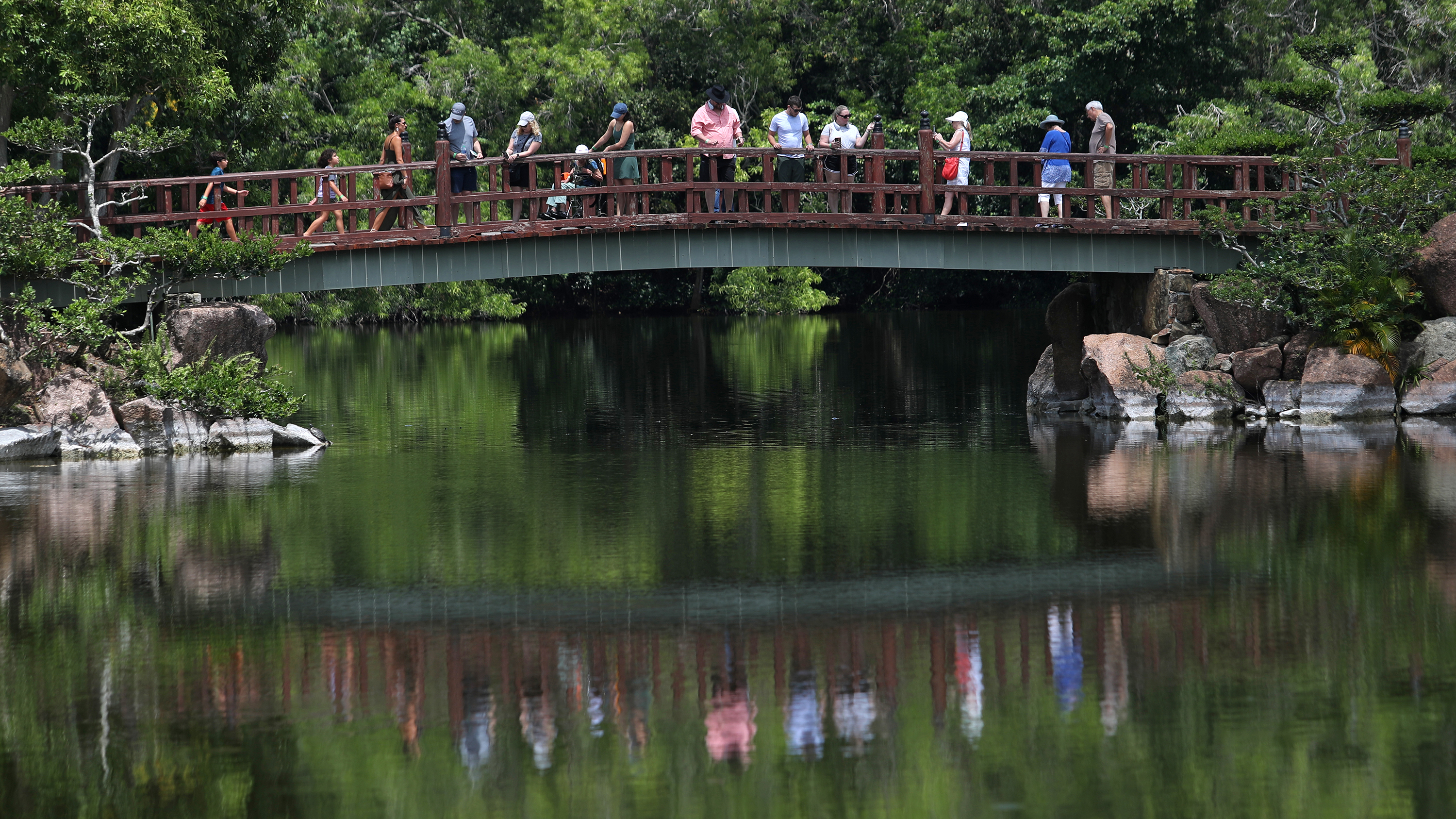 Visitors stroll on a bridge at the Morikami Museum and Japanese Gardens in Delray Beach, Florida.