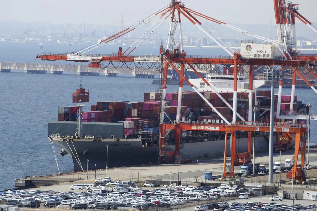 A container ship is loaded and unloaded at a container terminal at a port of Kawasaki near Tokyo on March 9, 2022. (Koji Sasahara/AP Photo)