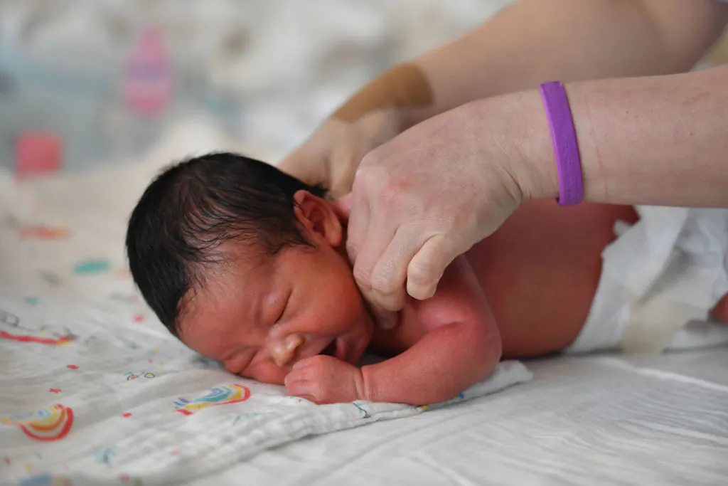 A nurse cares for a newborn baby at the Women and Children's Hospital in Fuyang, Anhui Province, China, on Aug. 8, 2022. (CFOTO/Future Publishing via Getty Images)