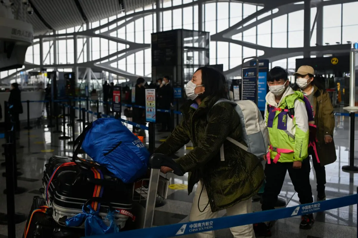 Passengers prepare to check in at Daxing International airport in Beijing on Jan. 19, 2023. (Wang Zhao/AFP via Getty Images)