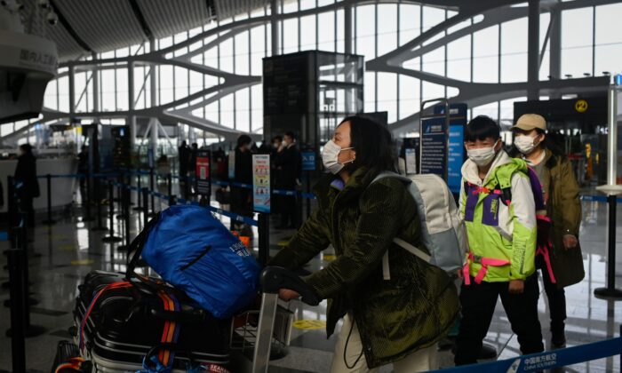 Passengers prepare to check in at Daxing International airport in Beijing on Jan. 19, 2023. (Wang Zhao/AFP via Getty Images)