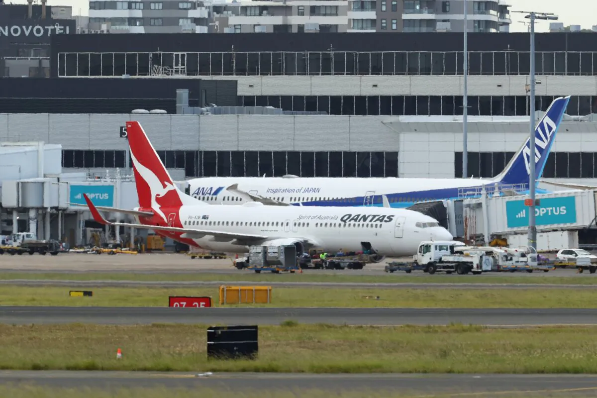 Qantas flight QF144 berths at a gate at Sydney Airport in Sydney, Australia, on Jan. 18, 2023. (Brendon Thorne/Getty Images)