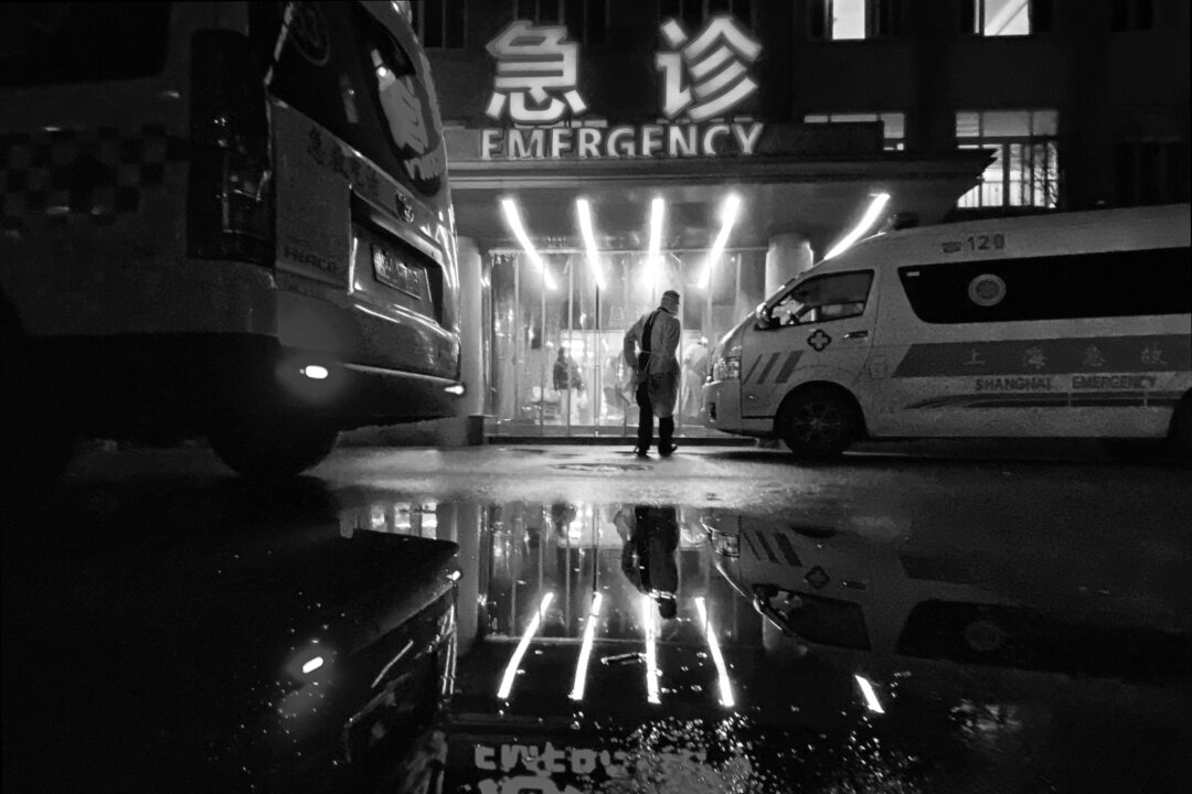 An ambulance driver walks into the busy emergency area of a hospital on January 13, 2023, in Shanghai, China. (Kevin Frayer/Getty Images)