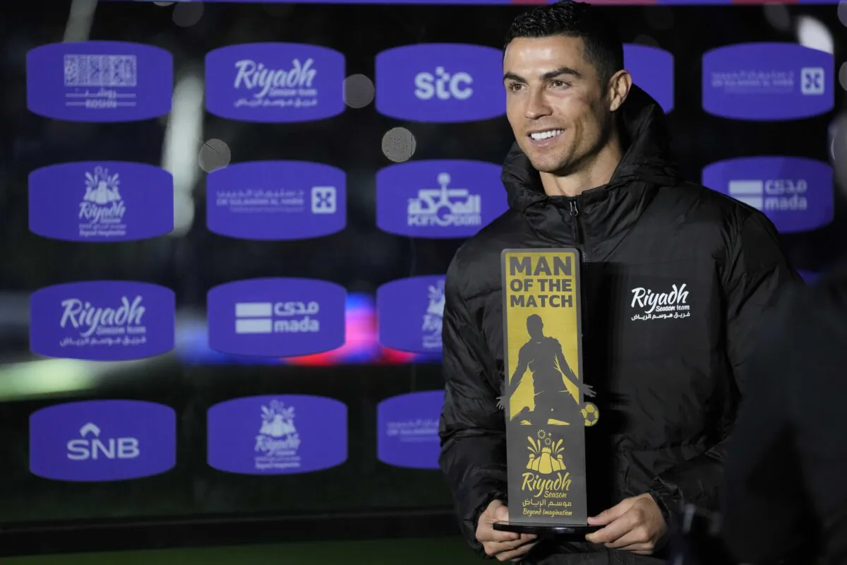 Cristiano Ronaldo holds a trophy as a 'Man of the match' after playing a friendly soccer match for a combined XI of Saudi Arabian teams Al Nassr and Al Hilal against PSG at the King Saud University Stadium in Riyadh, Saudi Arabia, on Jan. 19, 2023. (Hussein Malla/AP Photo)
