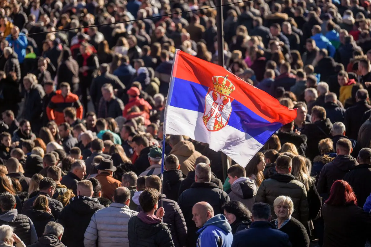 Kosovo Serbs hold a Serbian flag as they take part in a demonstration after a gunman shot and wounded two Serbs, in Strpce, Kosovo, on Jan. 6, 2023. (Armend Nimani/AFP via Getty Images)
