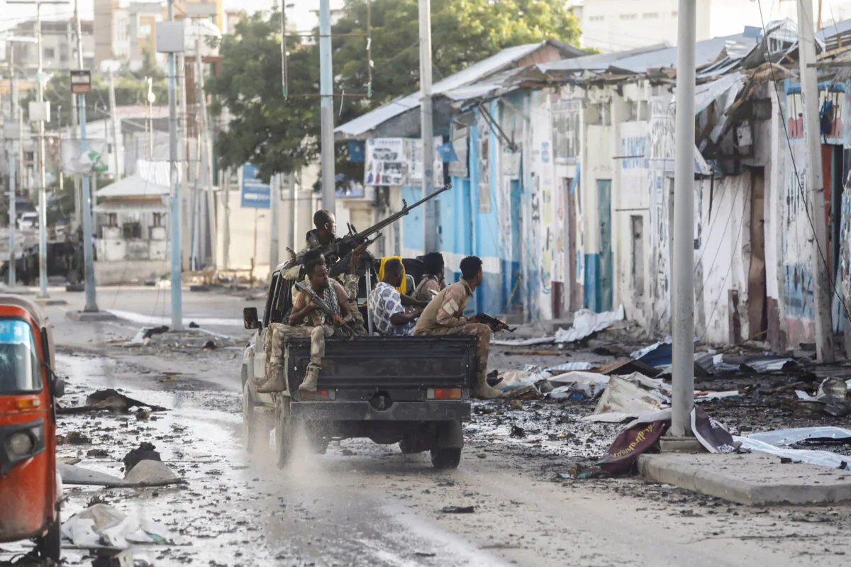 Somali security officers drive past a section of Hotel Hayat, the scene of an al-Shabaab group terrorist attack in Mogadishu, Somalia, on Aug. 20, 2022. (Feisal Omar/Reuters)