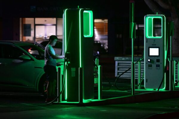 A driver charges his electric vehicle