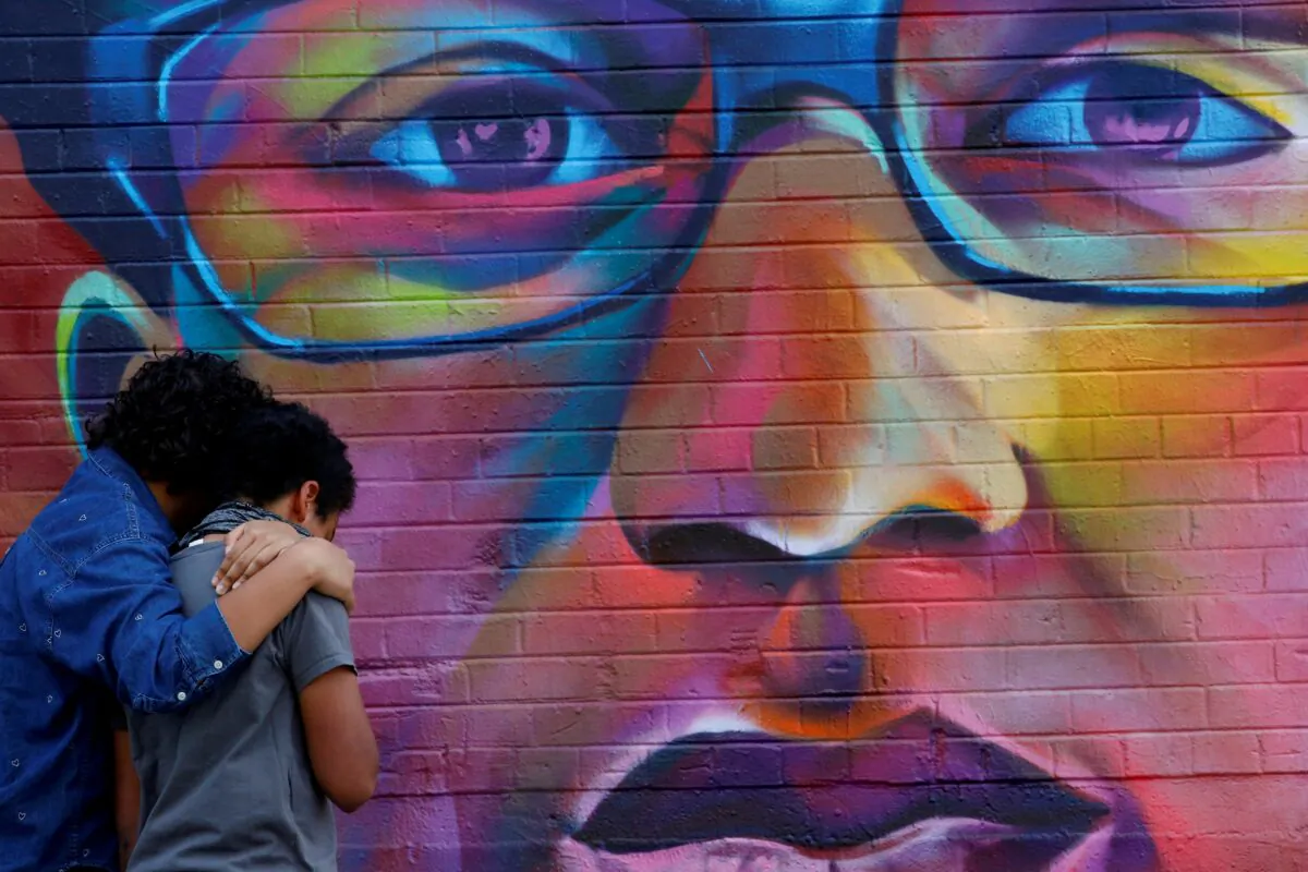 Noah and his older sister visit a mural of Elijah McClain, a 23-year-old Black man who died after an encounter with police officers, ahead of the one year anniversary of his death in Denver, Colorado, on Aug. 8, 2020. (Kevin Mohatt/Reuters, File Photo)