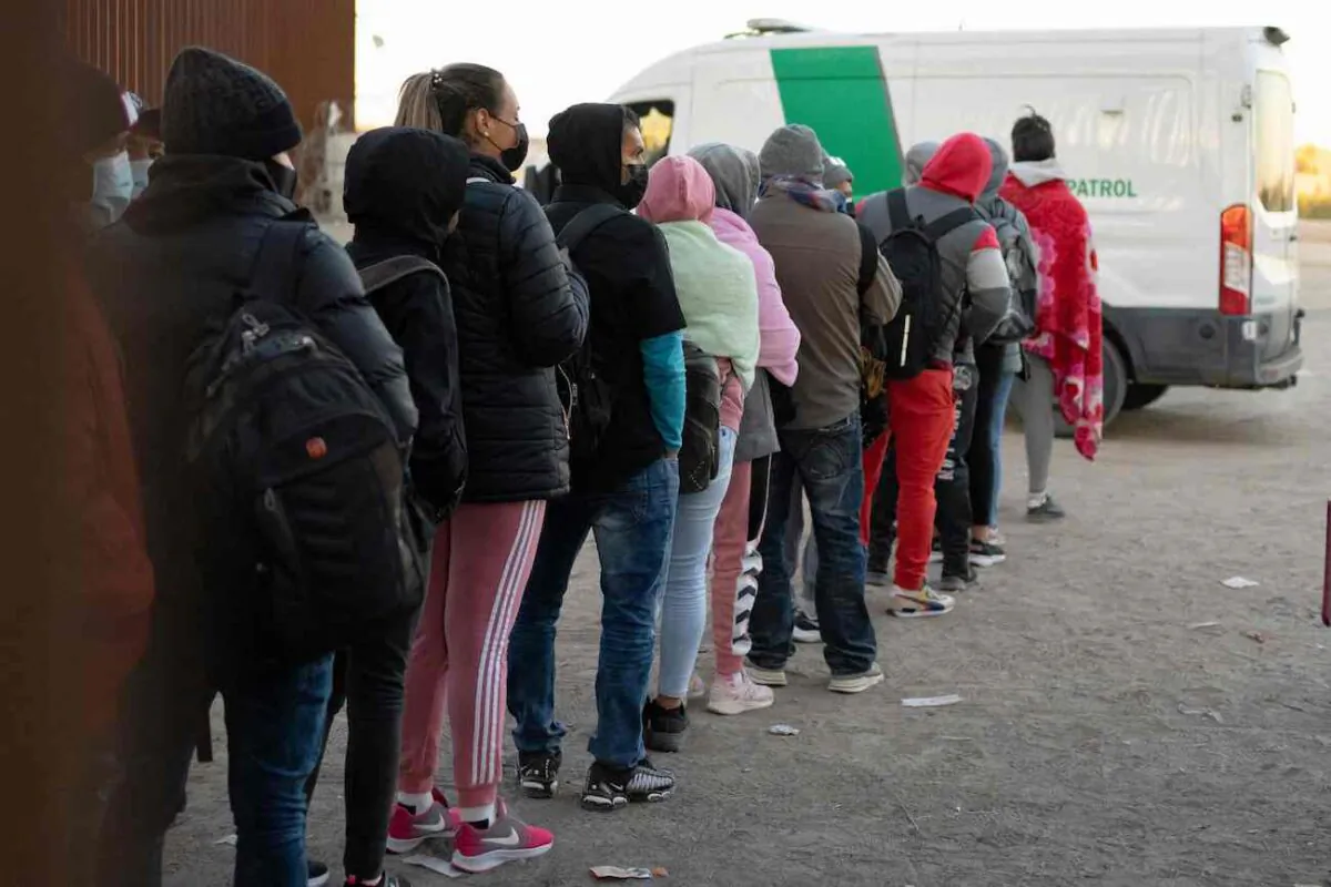 Illegal aliens seeking asylum line up to be processed by U.S. Customs and Border Patrol agents at a gap in the border fence near San Luis, Ariz., on Dec. 26, 2022. (Rebecca Noble/AFP via Getty Images)