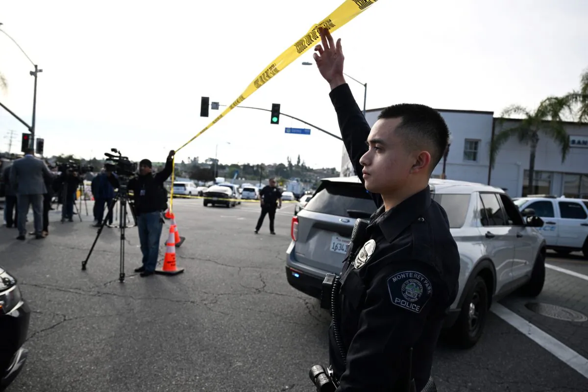 Police let investigators onto the scene of a mass shooting in Monterey Park, Calif., on Jan. 22, 2023. (Robyn Beck/AFP via Getty Images)