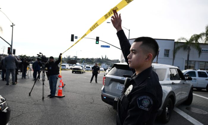 Police let investigators onto the scene of a mass shooting in Monterey Park, Calif., on Jan. 22, 2023. (Robyn Beck/AFP via Getty Images)