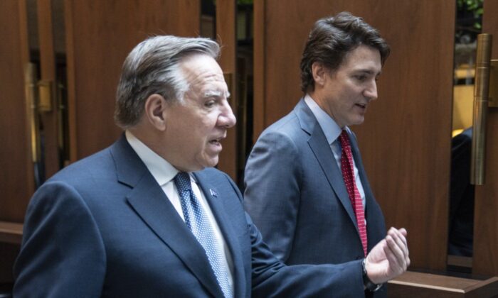 Prime Minister Justin Trudeau and Quebec Premier Francois Legault chat while walking to a meeting in Montreal on Dec. 20, 2022. (The Canadian Press/Paul Chiasson)
