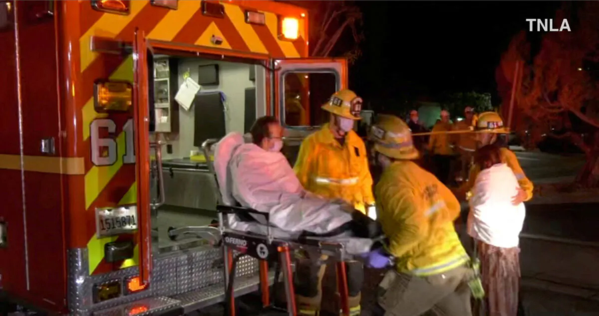 Screenshot from a video shows emergency responders assisting a person to an ambulance following a shooting at Monterey Park, California, on Jan. 22, 2023. (TNLA/Handout via Reuters)