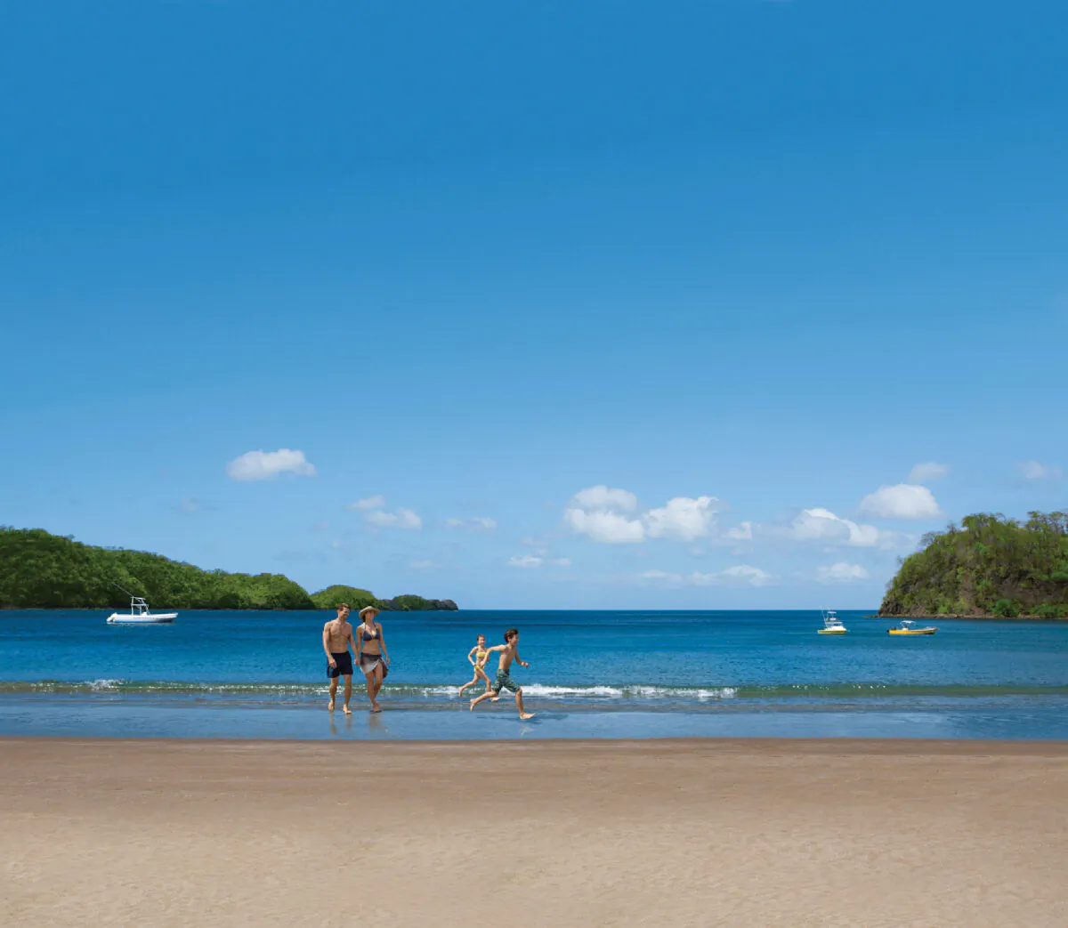 A family frolics on the beach at Dreams Las Mareas Costa Rica. (Photo courtesy of Dreams Las Mareas Costa Rica)