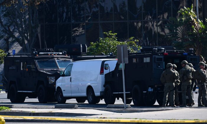 Law enforcement personnel outside the site in Torrance, Calif., where the alleged suspect in the mass shooting in which 10 people were killed in Monterey Park, California, is believed to be holed up on Jan. 22, 2023. (Robyn Beck/AFP via Getty Images)