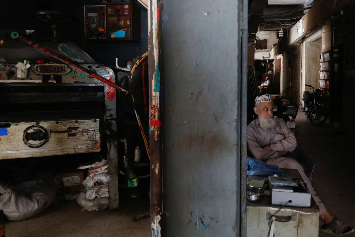 A man sits outside his shop during a countrywide power breakdown in Karachi, Pakistan, on Jan. 23, 2023. (Akhtar Soomro/Reuters)