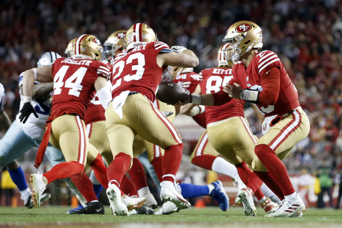 Brock Purdy (13) of the San Francisco 49ers hands off the ball to Christian McCaffrey (23) during the second half in the NFC Divisional Playoff game at Levi's Stadium in Santa Clara, Calif., on Jan. 22, 2023. (Lachlan Cunningham/Getty Images)