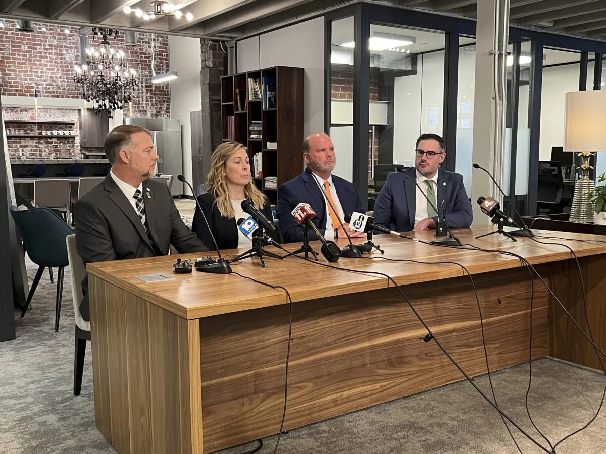 Shari Foltz (2nd L) speaks while her husband Cory Foltz (L) sit next to attorneys Rex Elliott (2nd R) and Sean Alto in a press conference where Elliott announced that the Foltz family will receive nearly $3 million from Bowling Green State University to settle its lawsuit in Bowling Green, Ohio, on Jan. 23, 2023. (Patrick Orsagos/AP Photo)