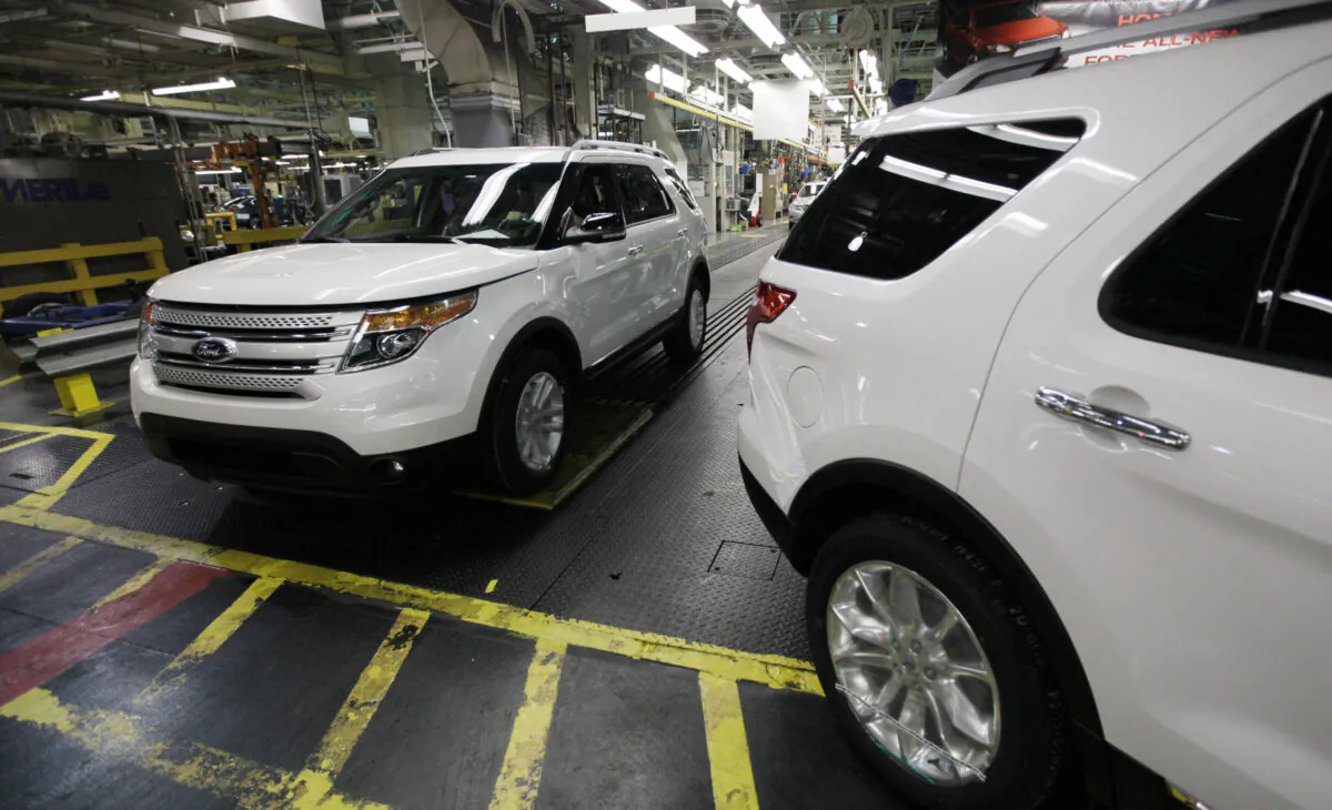 Plant employees drive 2011 Ford Explorer vehicles off the assembly line at Ford's Chicago Assembly Plant in Chicago on Dec. 1, 2010. (M. Spencer Green/AP Photo)