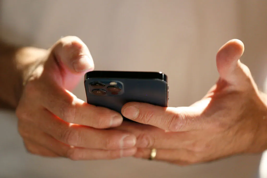 A person on their mobile phone in Salt Lake City, Utah, on Aug. 4, 2021. (George Frey/Getty Images)