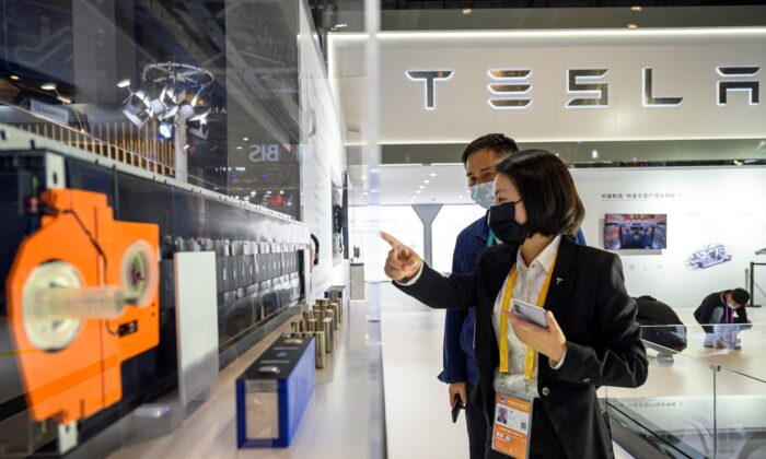 People visit the Tesla stand at the China International Import Expo (CIIE) in Shanghai on Nov. 5, 2021. (STR/AFP via Getty Images)