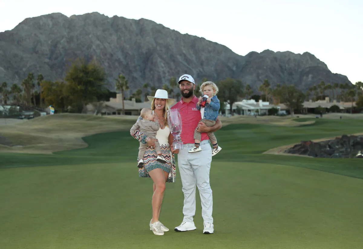 Jon Rahm of Spain celebrates with the trophy alongside wife Kelley, sons Kepa Cahill Rahm and Eneko Cahill Rahm after winning during the final round of The American Express at PGA West Pete Dye Stadium Course in La Quinta, Calif., on Jan. 22, 2023. (Meg Oliphant/Getty Images)