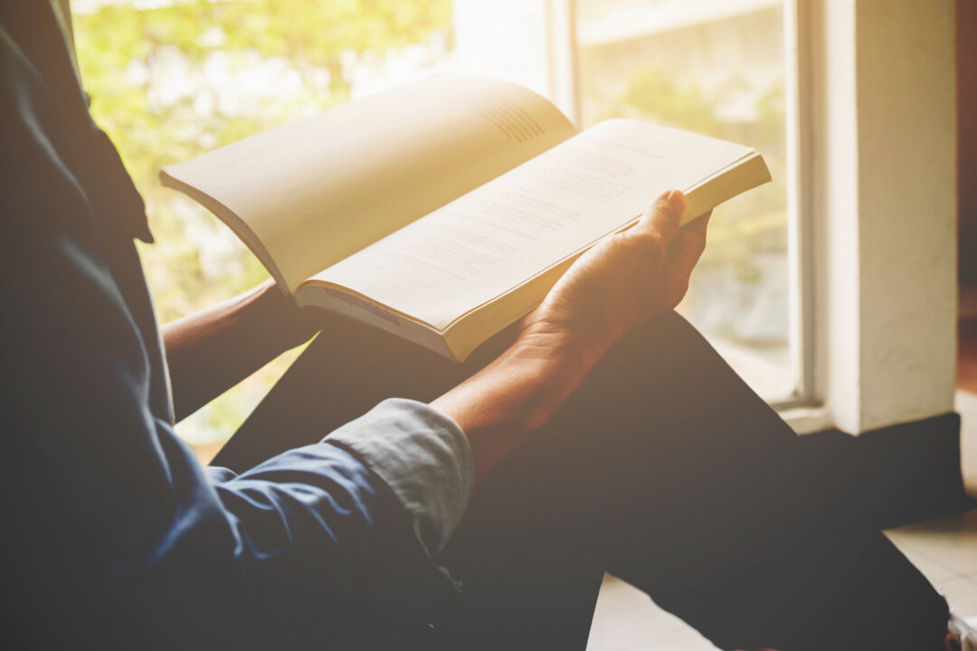 Research has indicated that reading books may cause people to form greater connections, or expand their perception of the outside world. (MIND AND I/Shutterstock)