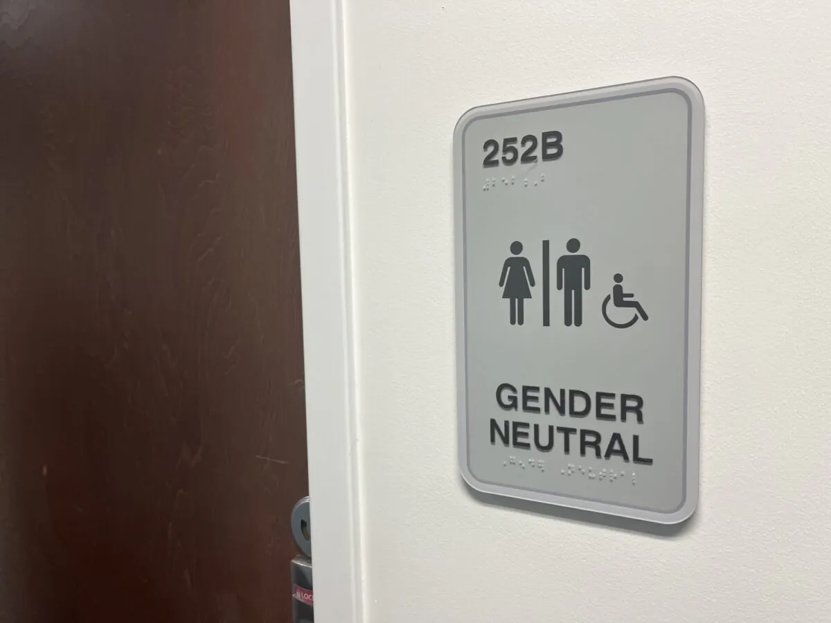 A restroom in a library at the University of Florida displays a sign indicating that it can be used by men or women. (Nanette Holt/The Epoch Times)
