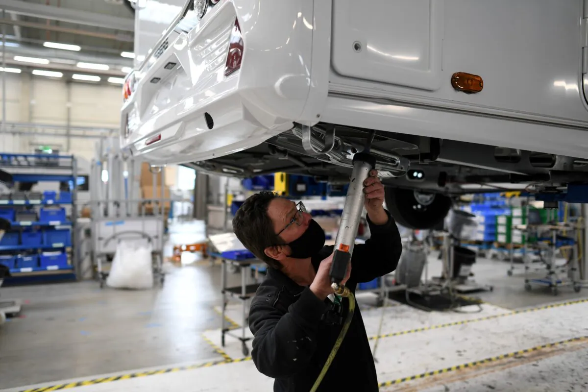 A worker assembles a vehicle at the Knaus-Tabbert AG factory in Jandelsbrunn near Passau, Germany, on March 16, 2021. (Andreas Gebert/Reuters)