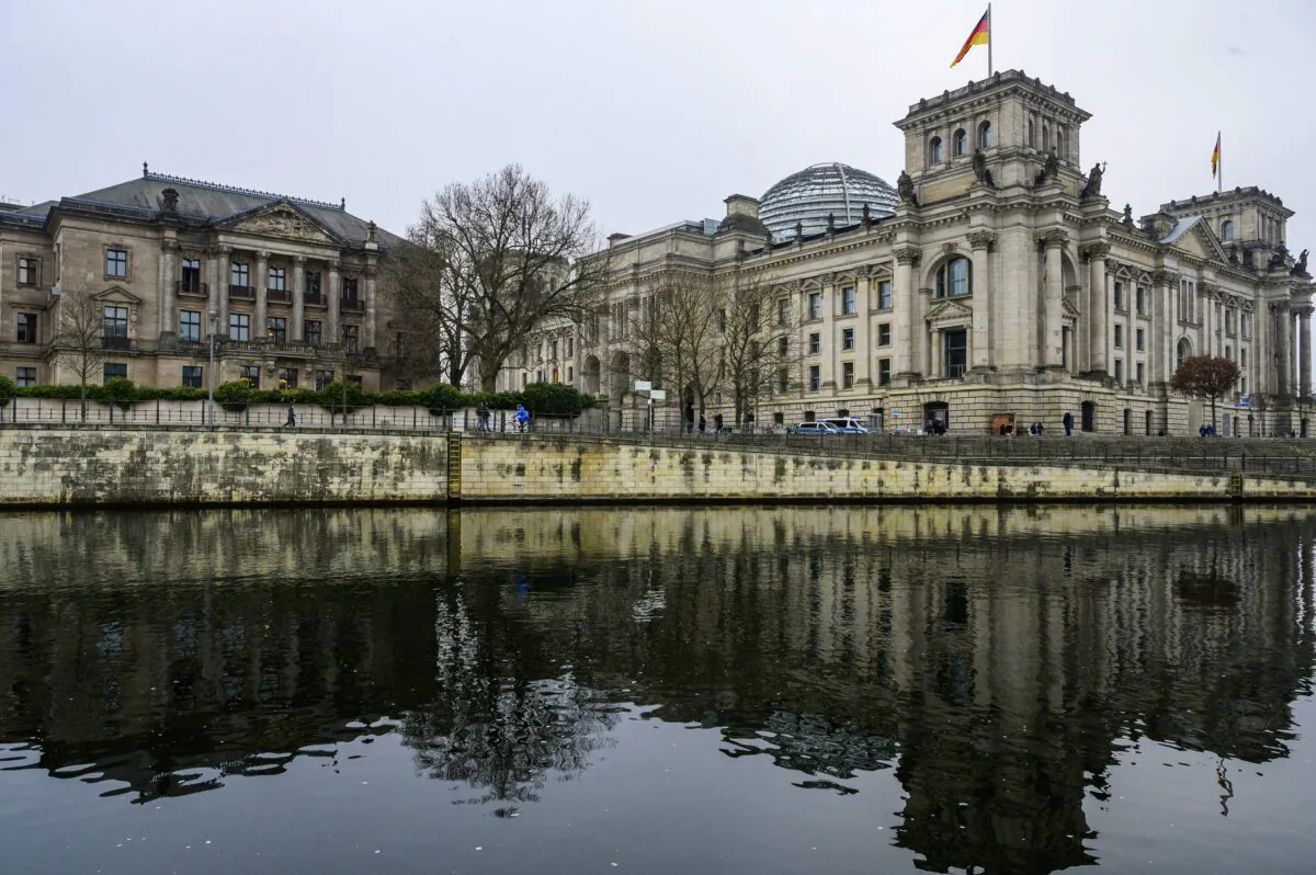 The Reichstag building (R), which houses Germany's Bundestag lower house of parliament, and the Jakob-Kaiser-Haus parliamentary complex (L) are reflected in the river Spree in Berlin on Jan. 20, 2023. (John MacDougall/AFP via Getty Images)