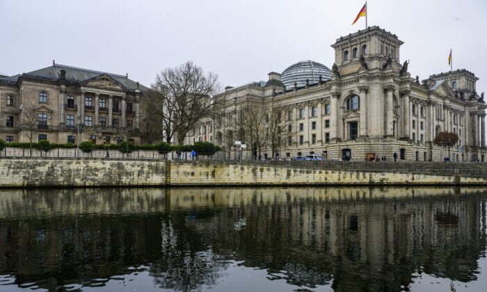The Reichstag building (R), which houses Germany's Bundestag lower house of parliament, and the Jakob-Kaiser-Haus parliamentary complex (L) are reflected in the river Spree in Berlin on Jan. 20, 2023. (John MacDougall/AFP via Getty Images)