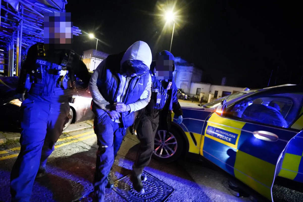 Officers from the Metropolitan Police arrest a suspect after a pursuit through Harlesden, northwest London, on Jan. 19, 2023. (PA Media)