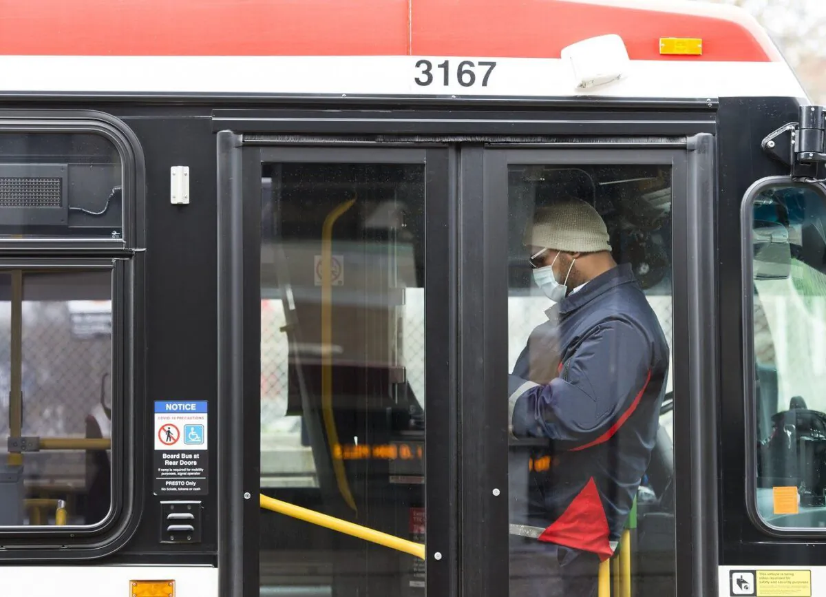 A TTC worker in a bus while on shift in Toronto on April 23, 2020. (Nathan Denette/The Canadian Press)