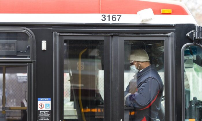 A TTC worker is shown in a bus while on shift in Toronto on April 23, 2020. (Nathan Denette/The Canadian Press)