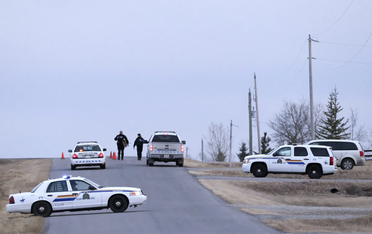 RCMP officers respond to an incident near Cochrane, Alta., on March 11, 2016. (Mike Ridewood/The Canadian Press)