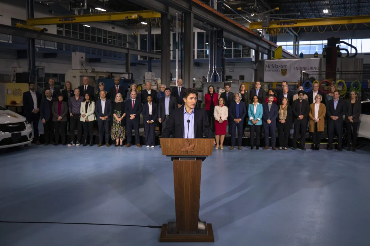 Prime Minister Justin Trudeau, joined by members of the Liberal Cabinet, speaks to the media at the McMaster Automotive Resource Centre, in Hamilton, Ont., during the final day of meetings at the Liberal Cabinet retreat, on January 25, 2023. (Nick Iwanyshyn/The Canadian Press)