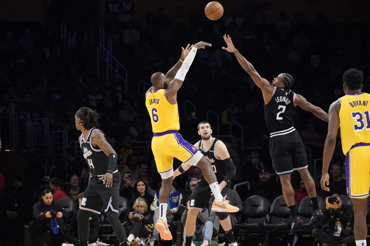 Los Angeles Lakers forward LeBron James (6) shoots as Los Angeles Clippers forward Kawhi Leonard (2) defends and guard Terance Mann (14), center Ivica Zubac (40) and center Thomas Bryant watch during the first half of an NBA basketball game in Los Angeles on Jan. 24, 2023. (Mark J. Terrill/AP Photo)