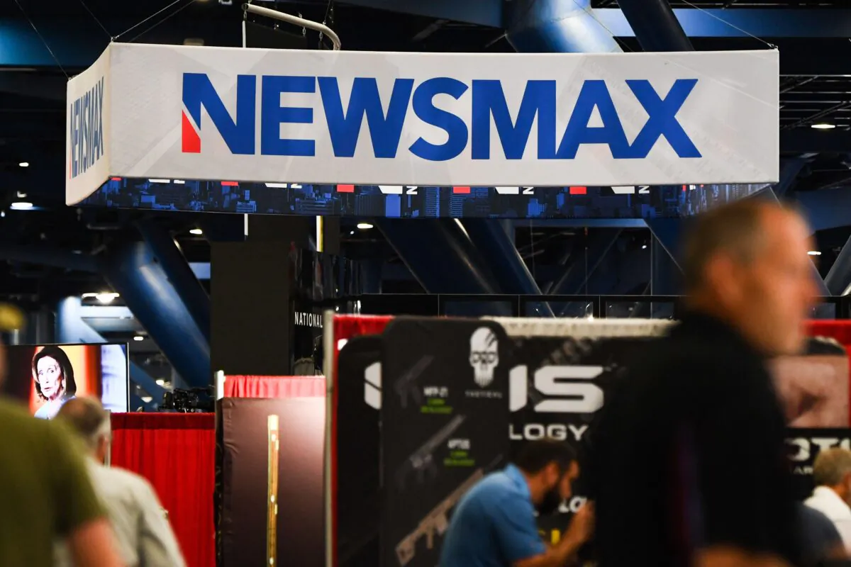 Signage for the Newsmax conservative television broadcasting network is displayed at a broadcast TV booth at the National Rifle Association (NRA) annual meeting at the George R. Brown Convention Center, in Houston, Texas on May 28, 2022. (Patrick T. Fallon/AFP via Getty Images)