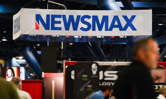 Signage for the Newsmax conservative television broadcasting network is displayed at a broadcast TV booth at the National Rifle Association (NRA) annual meeting at the George R. Brown Convention Center, in Houston, Texas on May 28, 2022. (Patrick T. Fallon/AFP via Getty Images)