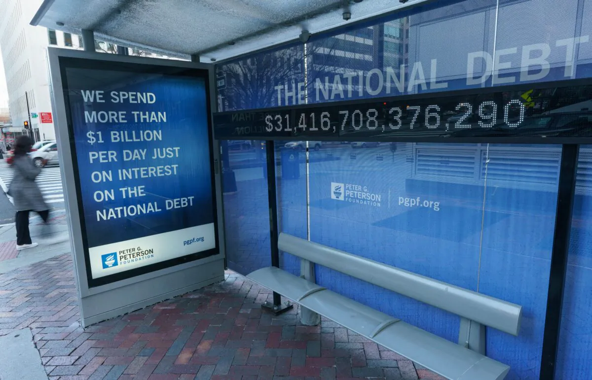 A sign at a bus shelter shows the U.S. national debt, in Washington, on Jan. 20, 2023. (Mandel Ngan/AFP via Getty Images)