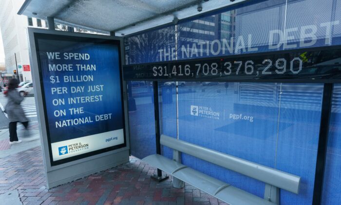 A sign at a bus shelter shows the U.S. national debt, in Washington on Jan. 20, 2023. (Mandel Ngan/AFP via Getty Images)