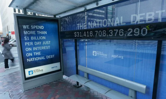 A sign at a bus shelter shows the U.S. national debt, in Washington, D.C., on Jan. 20, 2023. (Mandel Ngan/AFP via Getty Images)