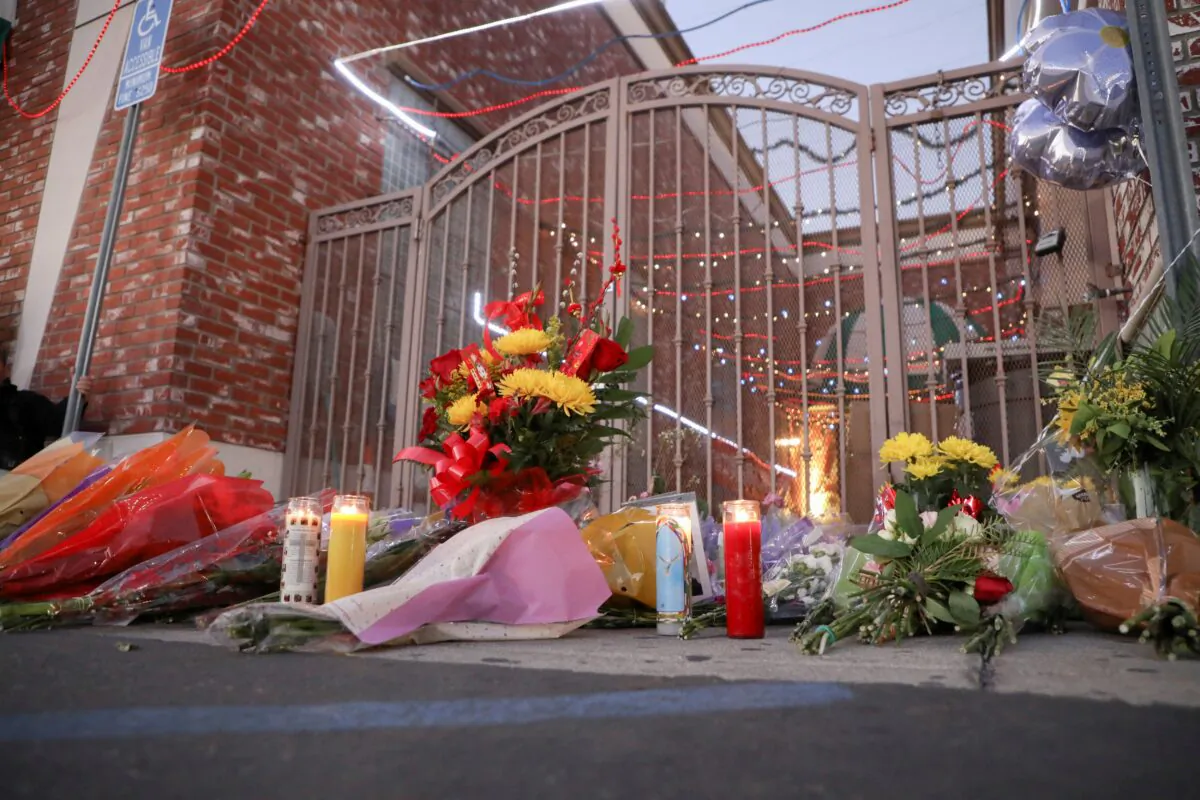 Flowers and candles are left outside the entrance of the Star Ballroom Dance Studio after a mass shooting during Chinese Lunar New Year celebrations in Monterey Park, Calif., on Jan. 23, 2023. (David Swanson/Reuters)