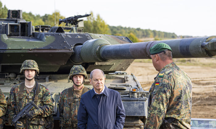German Chancellor Olaf Scholz stands with German army Bundeswehr soldiers at a Leopard 2 main battle tank during a training and instruction exercise in in Ostenholz, Germany, on Oct. 17, 2022. (Moritz Frankenberg/dpa via AP, File)