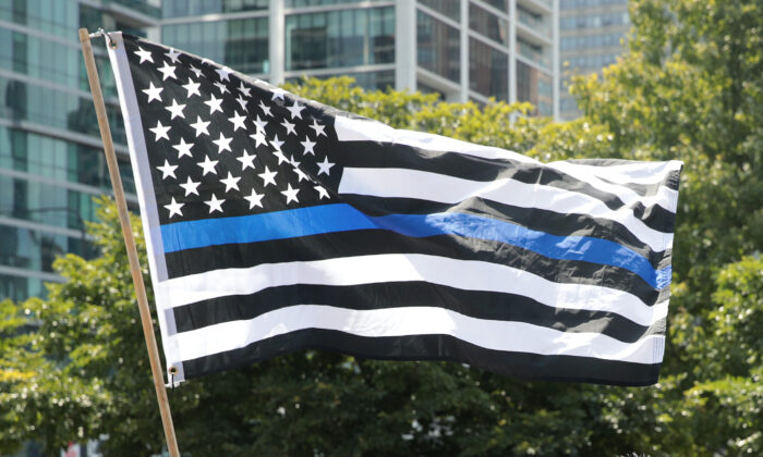 A thin blue line flag flies at a rally in Grant Park in Chicago, Illinois on July 25, 2020. (Scott Olson/Getty Images)