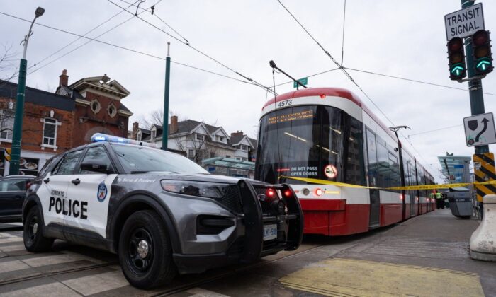 Police cars surround a TTC streetcar on Spadina Ave., in Toronto on Jan. 24, 2023 after a stabbing incident. (The Canadian Press/Arlyn McAdorey)
